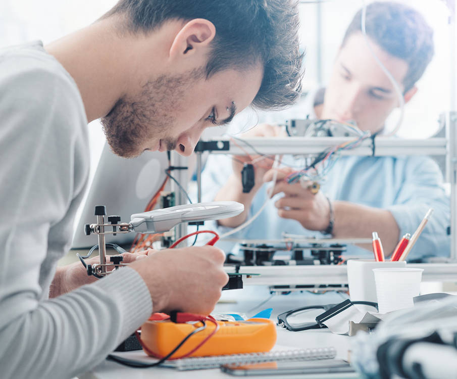 Engineers are working in the laboratory with wires and equipment